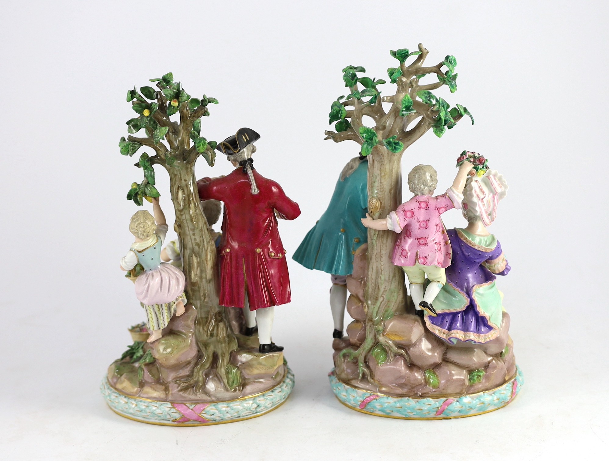 A pair of Meissen groups of apple pickers and flower gatherers, 19th century, 26cm and 27.5cm high